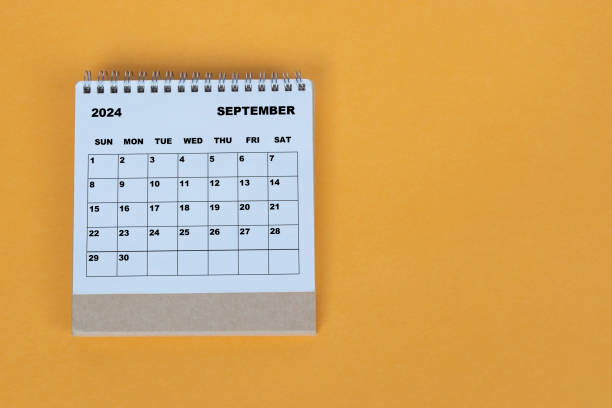 istock September 2024 desk calendar on yellow background. Directly above. Flat lay. 1784095583