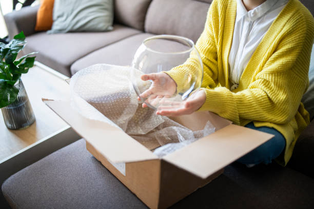 istock Woman opening parcel from online shopping. 1784097254