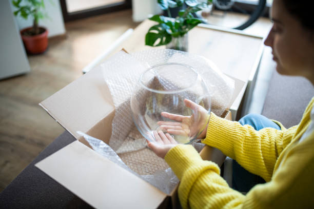 istock Woman opening parcel from online shopping. 1784097269