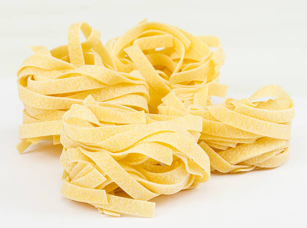istock Italian pasta fettuccine nest isolated on white background 178410137