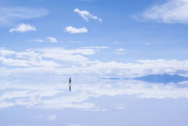 Walking Man in Salar de Uyuni, Bolivia stock photo