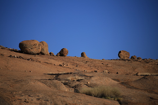 sunburned granite rocks, blue sky background