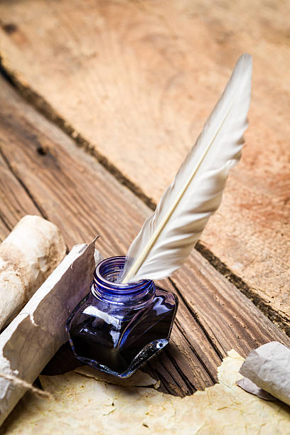istock Blue ink with feather on old wooden table 178410483
