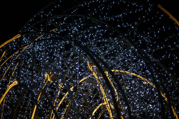 istock Garlands in dark. Bright light bulbs on black background. Decorating city during holidays. 1784112785