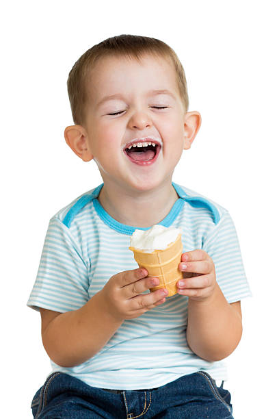istock happy kid boy eating ice cream in studio isolated 178411359