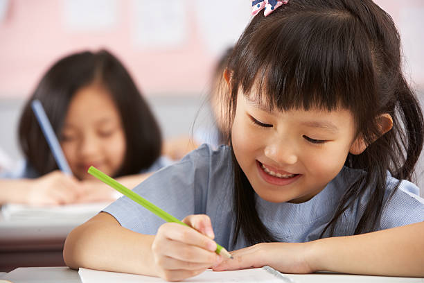 istock Chinese children working at desks in their classroom 178411683