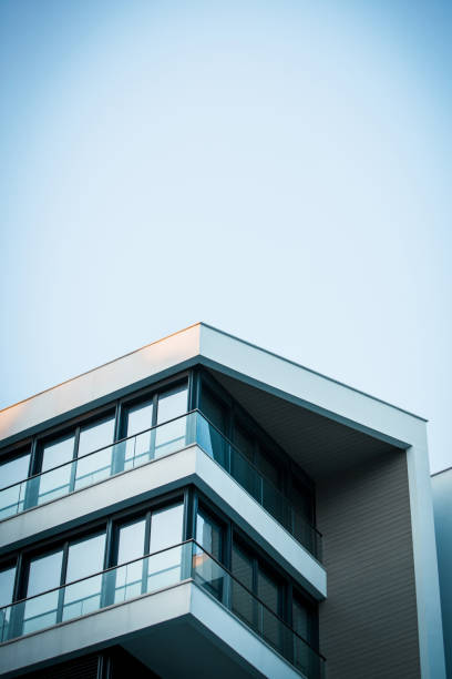 New modern apartment building and old houses, white background with copy space, full frame horizontal composition