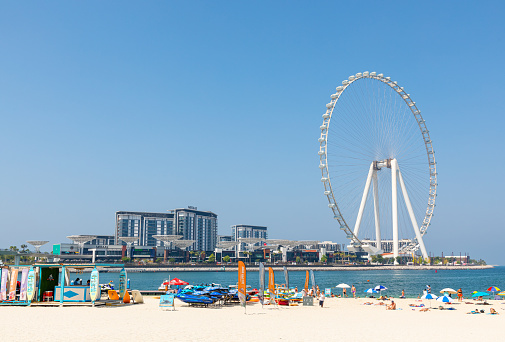Dubai, United Arab Emirates - June 21, 2023: Bluewaters island in Dubai with Ain Dubai Ferris wheel seen from JBR beach in Marina area. The tallest giant observation wheel ever built