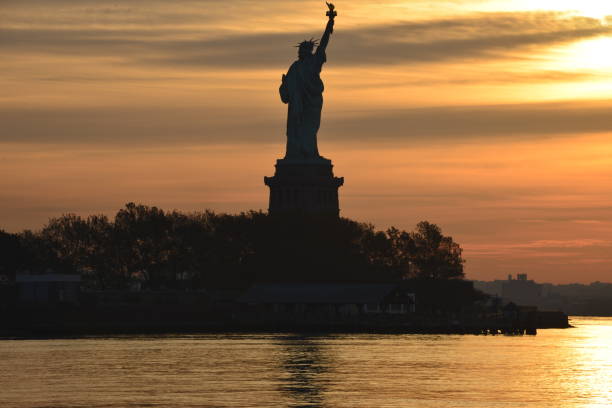 istock Silhouetted Statue Of Liberty During Sunrise 1784122443