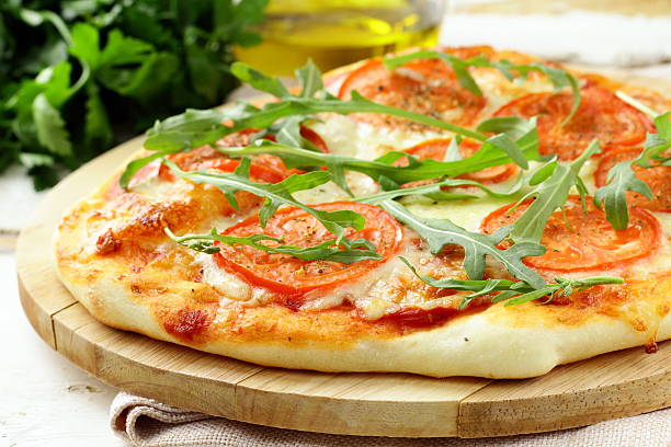 istock Margarita pizza with tomatoes and  arugula 178412270
