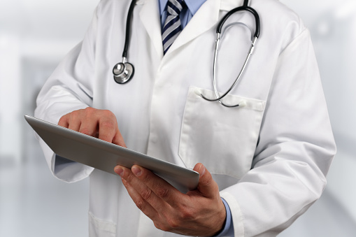 Doctor in hospital using a digital tablet