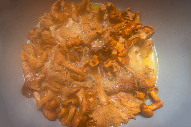 istock Close up of Chanterelle Mushrooms simmering in a pan 1784130689