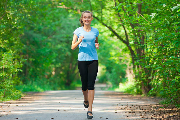 istock Young woman jogging outdoors 178413498