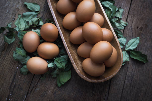 Fresh eggs in on old wooden background