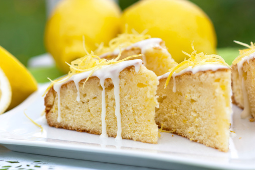 pieces of lemon cake with lemon zest topping and icing sugar