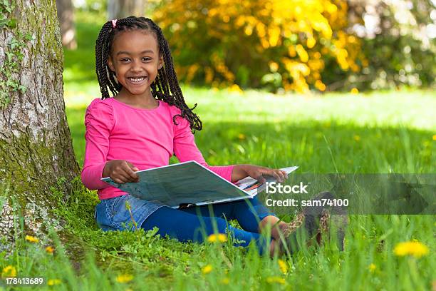 Cute Young Little Girl Reading Book In Park Stock Photo - Download Image Now - Child, Reading, Cartoon