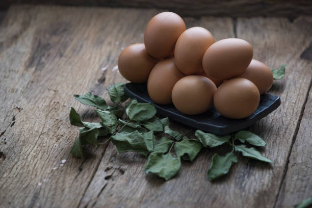 Fresh eggs in on old wooden background
