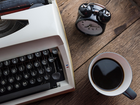 Vintage black typewriter on decorated wooden table