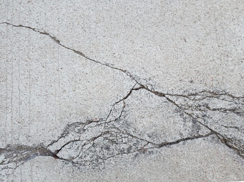 The concrete surface material is cracked.