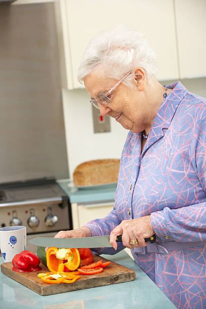 istock Senior woman chopping vegetables in domestic kitchen 178414657