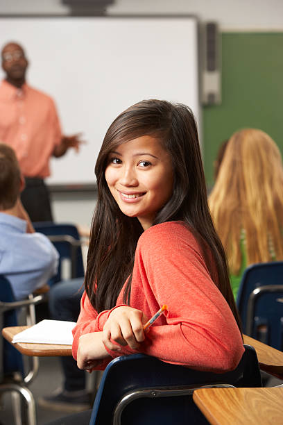 istock Woman smiling in class and looking away from the teacher 178415980