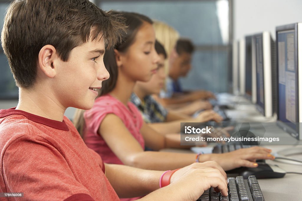 Elementary Students Working At Computers In Classroom Elementary Students Working At Computers In Classroom Sitting In A Row Elementary School Building Stock Photo