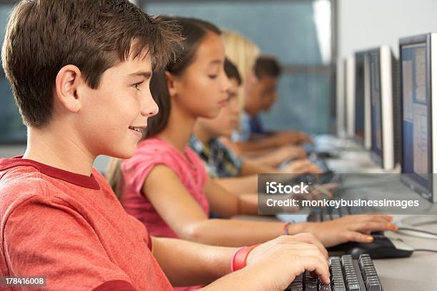 Elementary Students Working At Computers In Classroom Stock Photo - Download Image Now