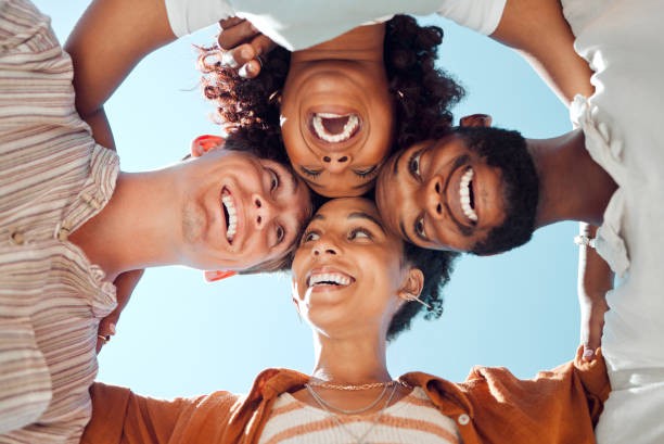istock Diversity, community and friends in a circle, relax, smile and bond while having fun in a city together. Freedom, face and happy people embracing in a trust huddle, excited at a social gathering 1784162464
