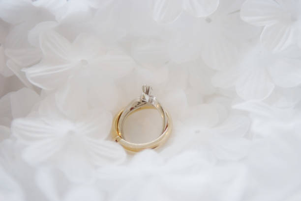 istock Elegant Wedding Ring on Floral Background 1784164738