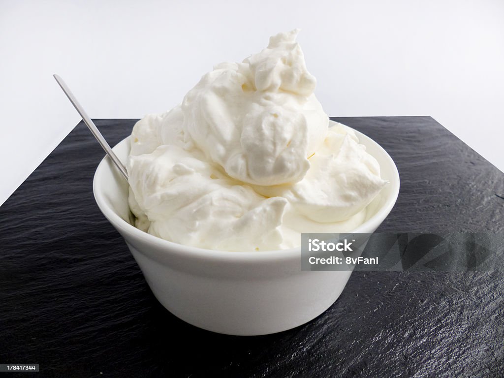 Cream on slate Cream on slate in a white bowl Bowl Stock Photo