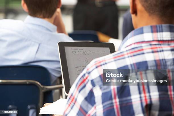 Male Pupil Using Digital Tablet In Classroom Stock Photo - Download Image Now - Digital Tablet, Rear View, High School Student
