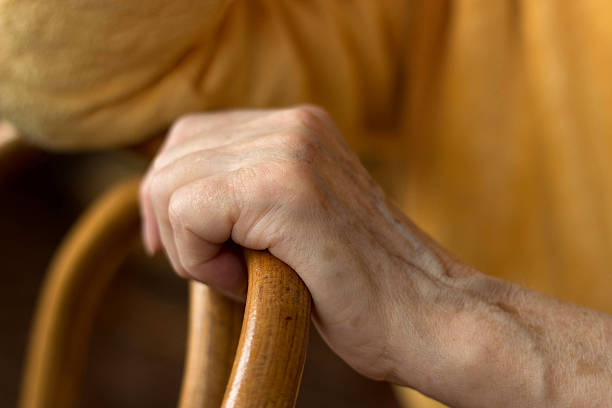 istock woman's hand rests on the back of a chair 178418824