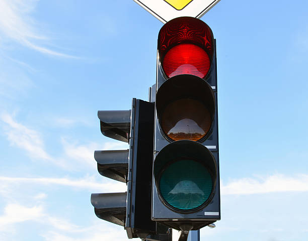 istock Red color traffic light blue sky in background 178419449