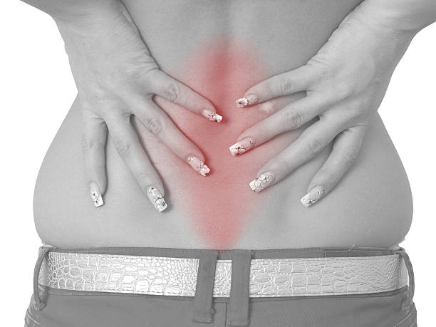 急性痛の女性の背中 - backache human spine lumbosacral region blue ストックフォトと画像
