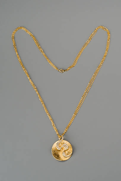 istock Golden pendant on a chain 178420097