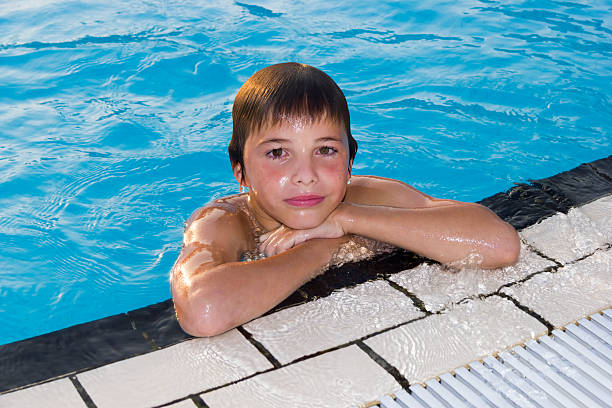 istock Cute boy swimming and playing in water 178420457
