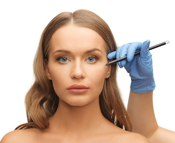 istock woman face and beautician hands 178420601