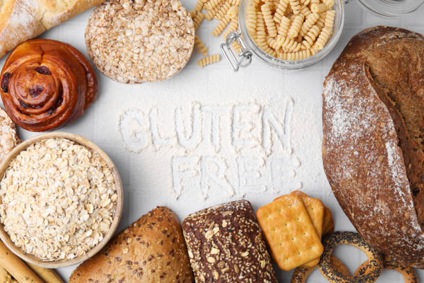 istock Different products and phrase Gluten free written with flour on white tiled table, flat lay 1784206607