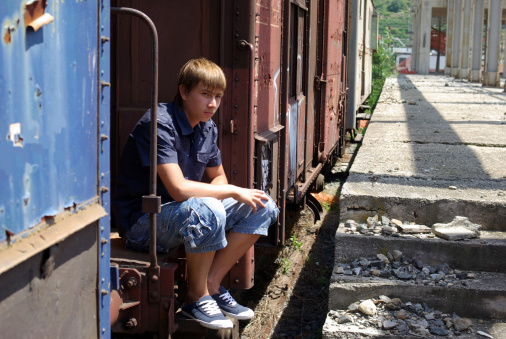 Boy in abandoned train station