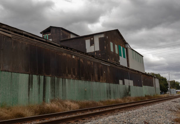 istock Sideview of abandoned warehouse with railroad track 1784227097