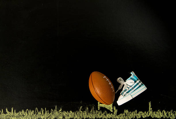 istock Football on tee with one shoe in black background 178422932