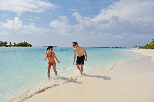 istock happy young couple have fun on beach 178422940