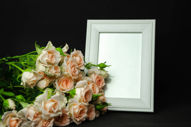 istock Peach blossom roses on black background with white postcard for writing 1784229854