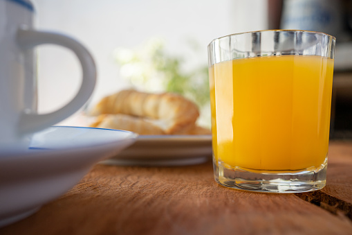 A breakfast of coffee and croissants with juice. This image depicts a delightful and typical breakfast combination featuring coffee, croissants, and juice, creating a cozy and delicious atmosphere to start the day.