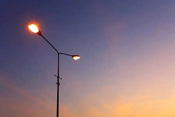 Photo of Street light illuminated sunset