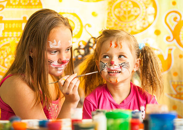 istock Two young funny sisters playing with painting 178424601