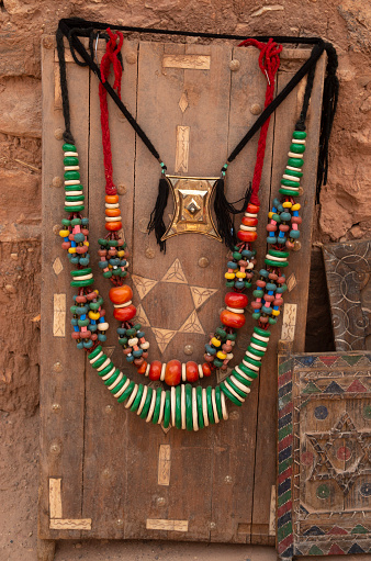 Old Moroccan carved interior wooden door and berber jewels in street trade in Ait Ben Haddou, Morocco