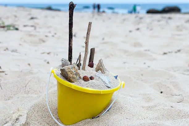 Photo of Bucket of beach sand, rocks, shells, etc