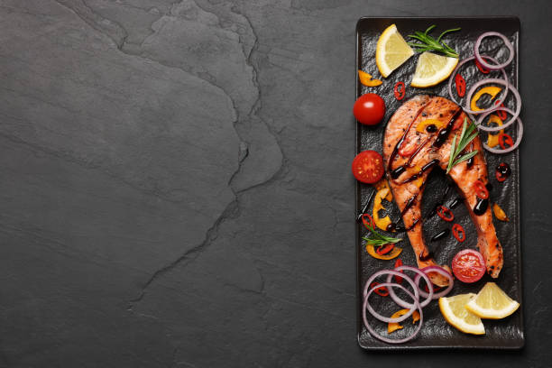 istock Tasty salmon steak served on black table, top view. Space for text 1784255712