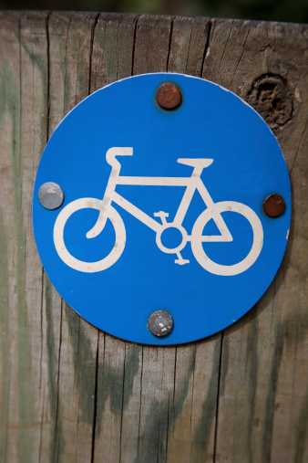 Blue Bicycle Lane Sign on Wooden Post